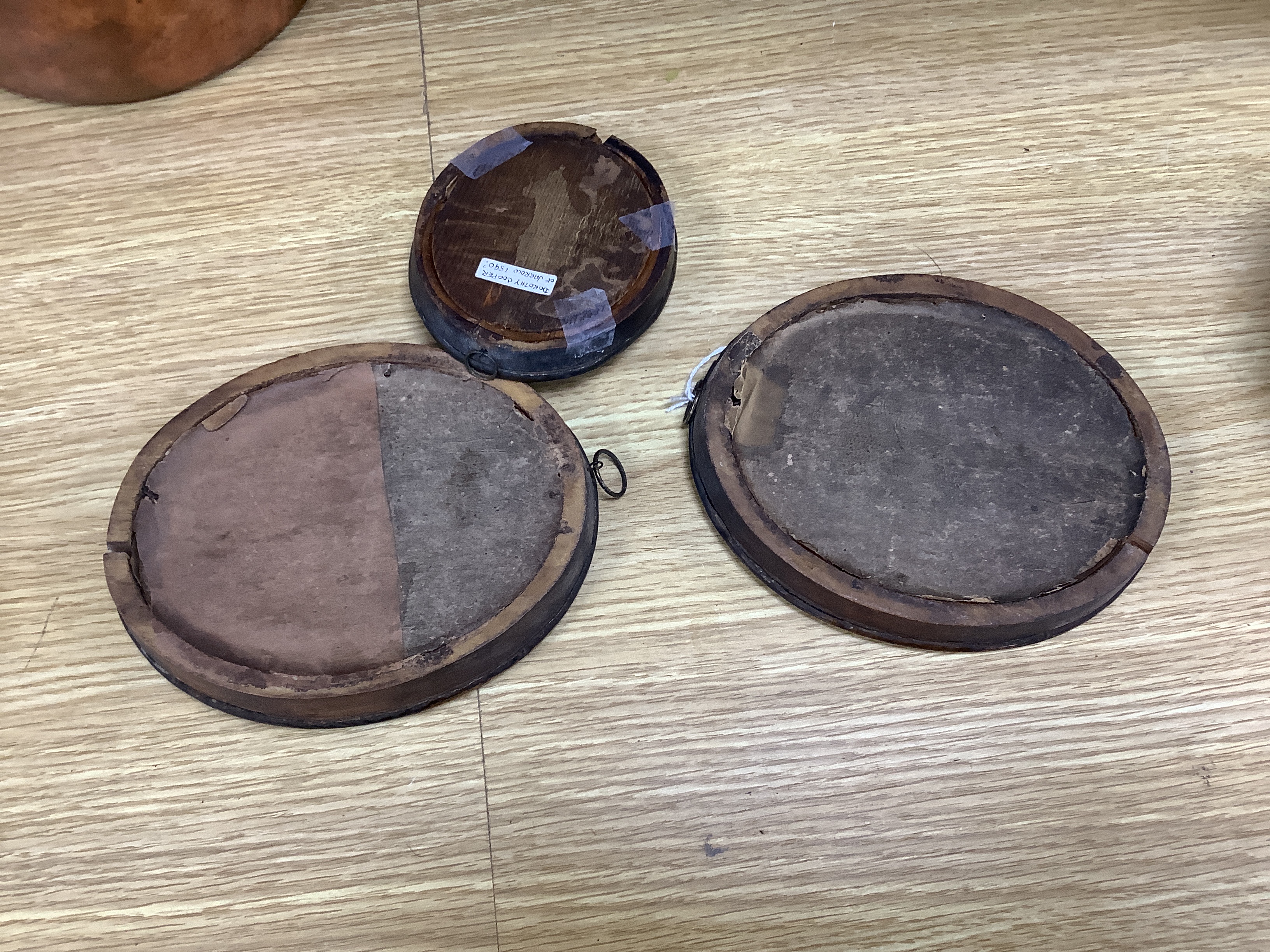 Three late Georgian silhouette portraits, verre eglomise mounts, largest 17cm high